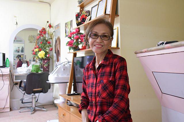 Bing Salanga sits in the hair salon where she’s worked for 29 years in Garapan, Saipan. 