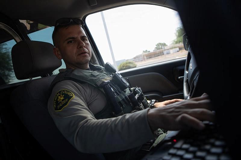 Imperial County Deputy Sheriff Pedro Millan enters notes after responding to a possible 5150 call in El Centro, Sept. 13, 2022. In Imperial County and elsewhere in California, many 5150 holds are initiated by police. (Zoë Meyers/inewsource)