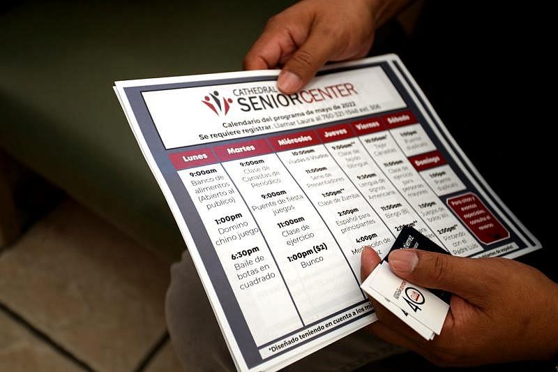 Luna's Hair Salon owner Jose Alfredo Xicay holds a calendar of events for the Cathedral City Senior Center inside his salon in Cathedral City, Calif., on Thursday, May 12, 2022. Taya Gray/The Desert Sun