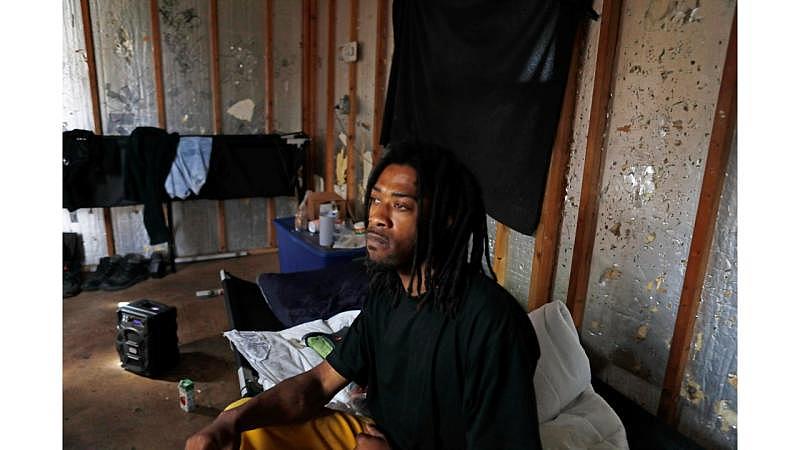 Vaughn Foster sits in his Oakland tiny home on Wednesday, August 17, 2022. The tiny home is much more rudimentary and has fewer amenities than most tiny homes in San Jose. (Shae Hammond/Bay Area News Group) 