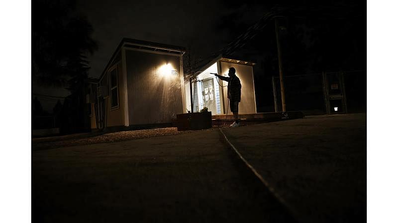 Hernandez waters plants at his tiny home community on Felipe Street in San Jose on Monday, Sept. 19, 2022. (Shae Hammond/Bay Area News Group) 