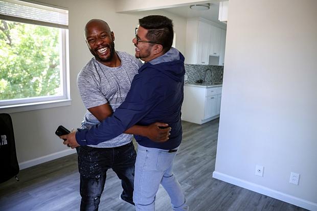 Henderson embraces a HomeFirst employee while moving into his apartment from a tiny home in San Jose on Friday, July. 22, 2022. (Shae Hammond/Bay Area News Group)