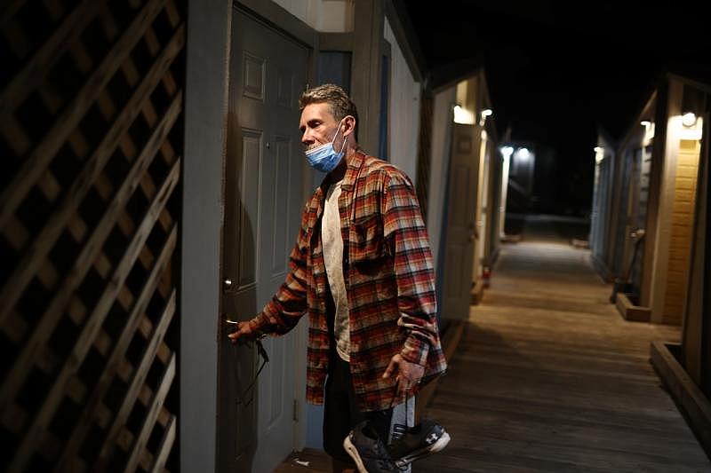 Hernandez enters his tiny home on Felipe Avenue in San Jose on Monday, Sept. 19, 2022. He recently moved into the tiny home after being kicked out of another tiny home. (Shae Hammond/Bay Area News Group)