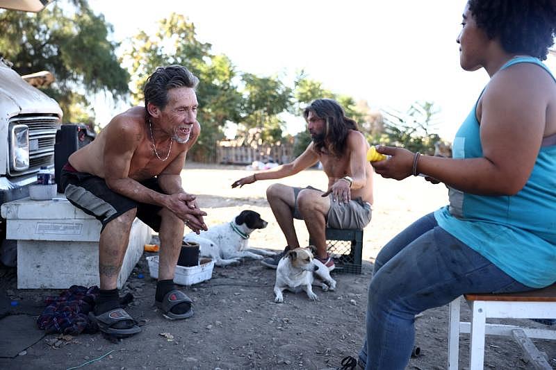 Robert Hernandez, left, hangs out with friends at an encampment on West Hedding Street in San Jose on Tuesday, Sept. 21, 2022. (Shae Hammond/Bay Area News Group)