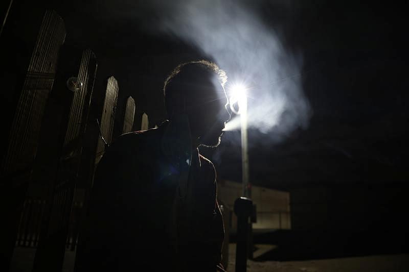 Hernandez smokes outside his tiny home on Felipe Avenue in San Jose, Calif., on Monday, Sept. 19, 2022. (Shae Hammond/Bay Area News Group)