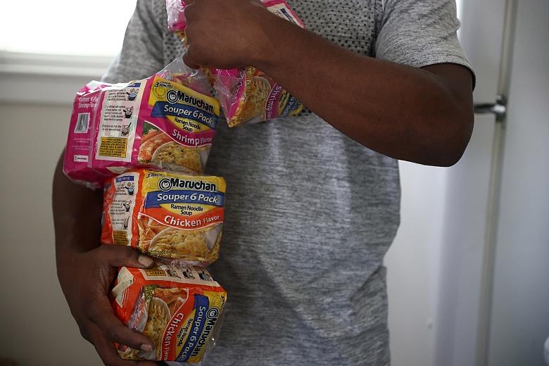 Henderson holds packets of ramen in his apartment in San Jose on Tuesday, Aug. 2, 2022. (Shae Hammond/Bay Area News Group)