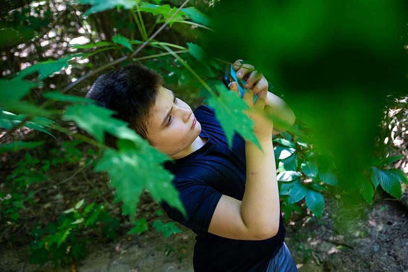 Kai Atallah identifies plants with an app during a field trip to a local park Friday, Sept. 9, 2022, in Holland. CODY SCANLAN/HOLLAND SENTINEL