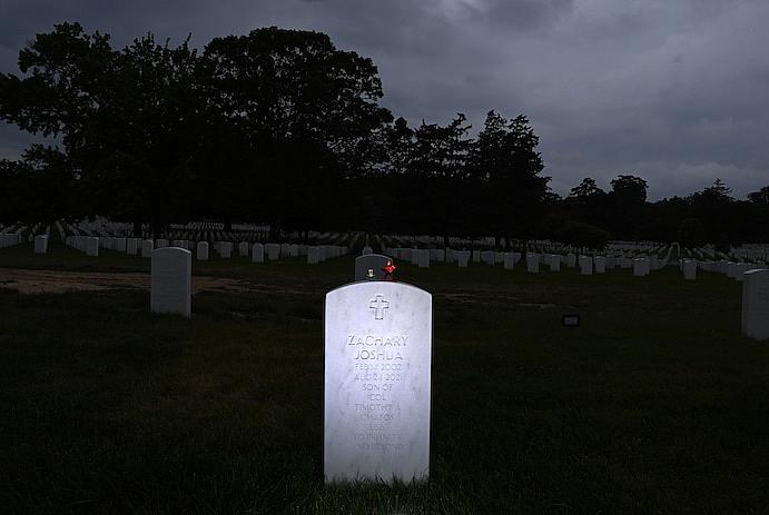 Figures of Buzz Lightyear and Mr. Incredible adorn Zach's headstone at Arlington National Cemetery. (Matt McClain/The Washington Post)