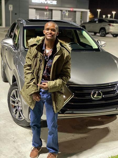 Fred Harris, who had an IQ of 62, stands in front of a Lexus SUV. Fred, who was 19 and had special needs, was killed in an incident with an inmate in the Harris County Jail in 2021.  Courtesy/Fred Harris family