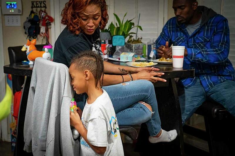 Seven-year-old Jagger talks with his mom, Dallas Garcia, as they finish dinner and prepare to play the board game Trouble in February in their Stafford home. Before the death of Jagger's brother, Fred Harris, the family played board games together every Friday. This is the first time they've played board games since Fred's death last year.   Mark Mulligan, Houston Chronicle / Staff photographer