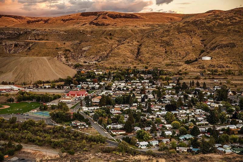 The cliffs surrounding the town of Coulee Dam are scenic, but getting internet service in this remote terrain is problematic. On the left is the Lake Roosevelt school campus. (Amanda Snyder / The Seattle Times)