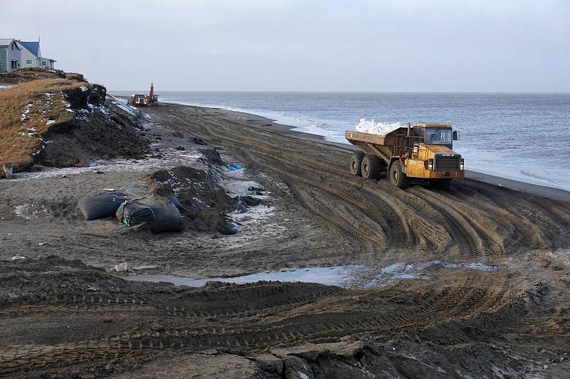 North Slope Borough crews work to protect the shoreline of Utqiagvik, Alaska from storm surges in an October 2018 file photo. As sea ice forms later and less predictably, coastal erosion can threaten sewer and water infrastructure even in communities that have it. (Yereth Rosen / Reuters) North Slope Borough crews work to protect the shoreline of Utqiagvik, Alaska from storm surges in an October 2018 file photo. As sea ice forms later and less predictably, coastal erosion can threaten sewer and water infrastructure even in communities that have it. (Yereth Rosen / Reuters)