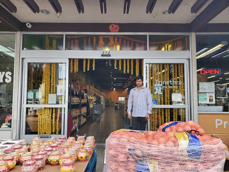 Surya Dixit, owner of Trinethra Supermarkets, in front of his store in Santa Clara. (Image Credit: Srishti Prabha)