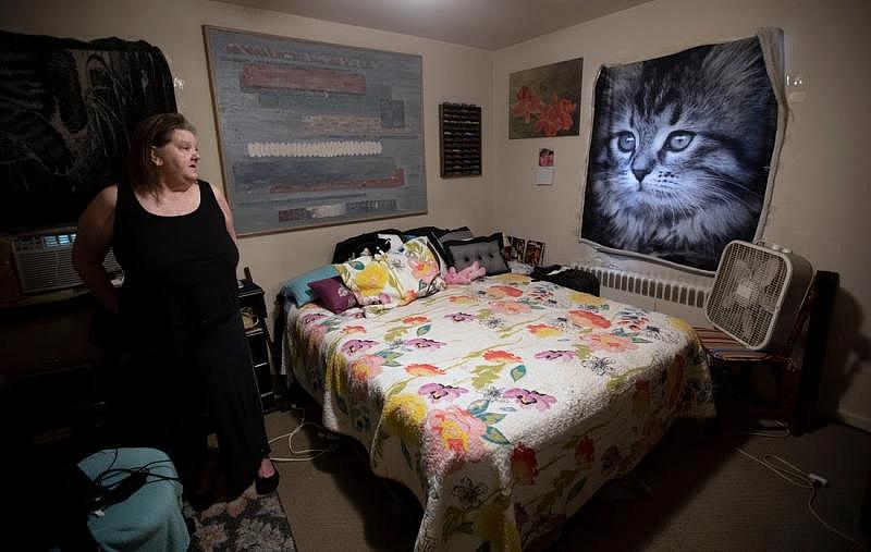 Paula Pierce, 62, looks around her bedroom where she hasn't slept in the past year. She sleeps on the couch near the front door.  LIZ DUFOUR/CINCINNATI ENQUIRER