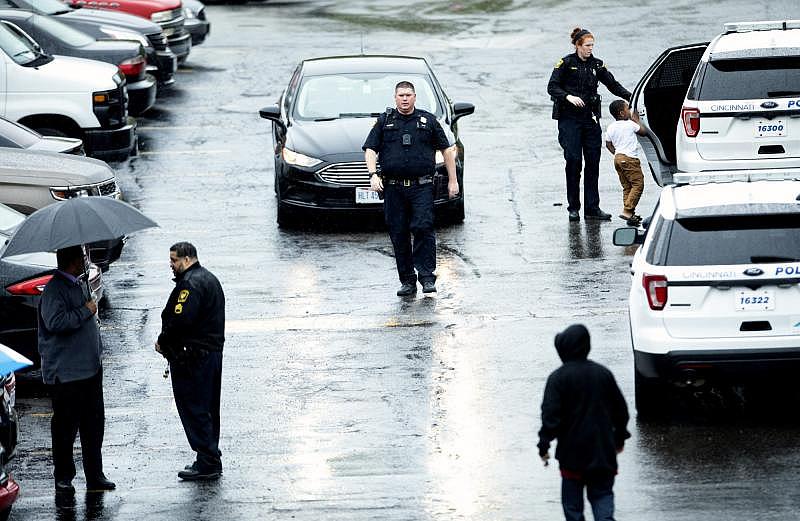 A Cincinnati police officer helps Kayden Allen, then 5, into a cruiser after his mom, Patricia Woods, was killed in their apartment at the Renata Apartments on the 2400 Block of Westwood Northern Boulevard on Friday, April 17, 2020 in Westwood. Her daughter, Kay-Lia McCree, then 14 months, was also in the home. Her boyfriend, Marcus Reed has been charged with aggravated murder. His trial is set for November 2021. ALBERT CESARE / THE ENQUIRER