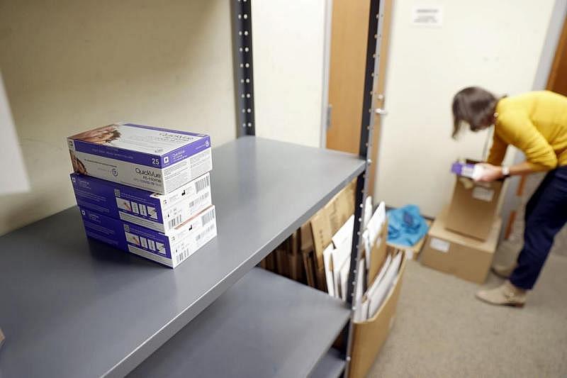 Amy Popovich, nurse manager for the Richmond and Henrico health districts, prepares rapid test kits to go out to community partners at the Richmond City Health District in Richmond, Va. on January 11, 2022. EVA RUSSO/TIMES-DISPATCH  Eva Russo