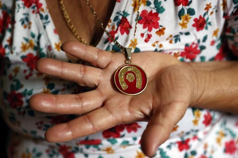 Maria Fuentes holds a pendant that was her husband's. Yuki Mendez died of COVID-19 at Chippenham Hospital on July 28, 2020. He was 40. Photos by Eva Russo/Times-Dispatch Maria Fuentes holds a pendant that was her husband's. Yuki Mendez died of COVID-19 at Chippenham Hospital on July 28, 2020. He was 40. Photos by Eva Russo/Times-Dispatch