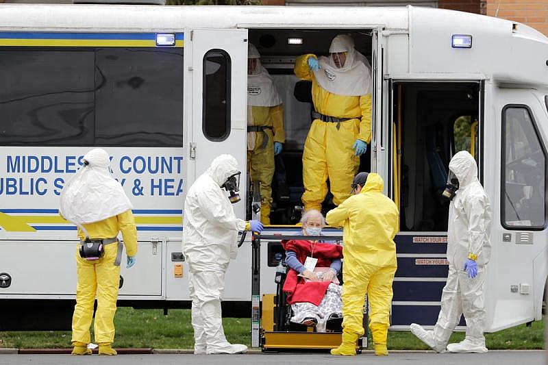 As nursing homes became overwhelmed with COVID-19 patients, some sought to transfer residents to other facilities. Here, residents from St. Josephs' Senior Home in Woodbridge, New Jersey, are helped onto a bus on March 25, 2020. GRETCHEN EHLKE, AP; SETH WENIG, AP