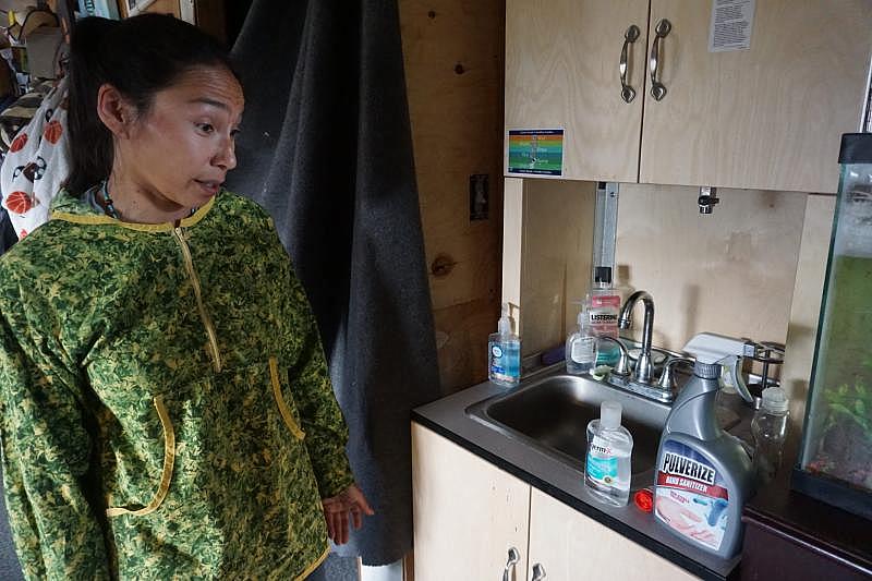 Blanche Okbaok-Garnie, the mayor of Teller, Alaska — which isn't served by water and sewer pipes — shows the Mini-PASS home sanitation system in her house. (Yereth Rosen)