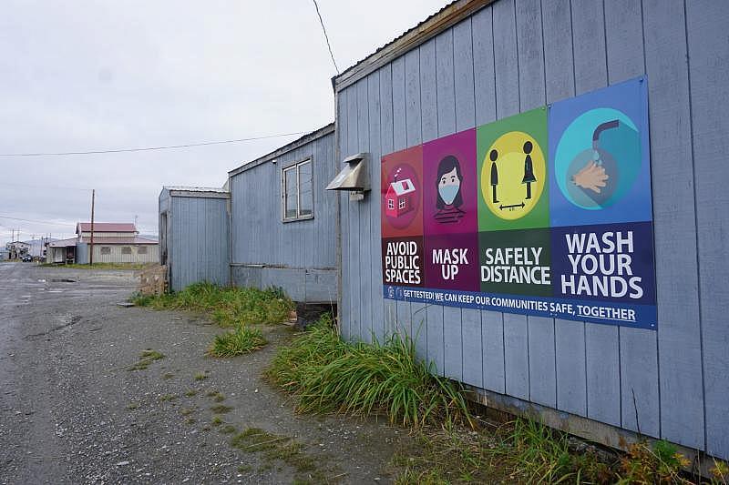 A sign in the rural Alaska village of Teller urges residents to take COVID-19 precautions. (Yereth Rosen)