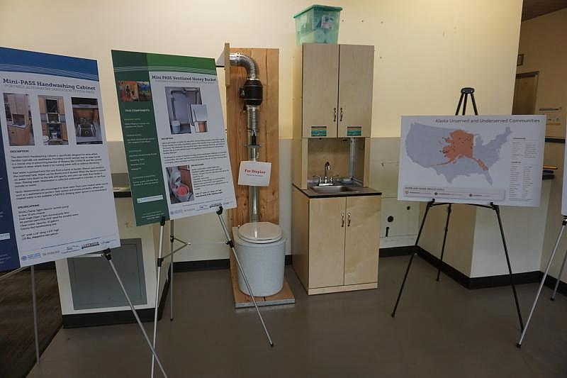 A display at the Alaska Native Tribal Health Consortium in Anchorage shows a Mini-PASS in home sanitation system. (Yereth Rosen)
