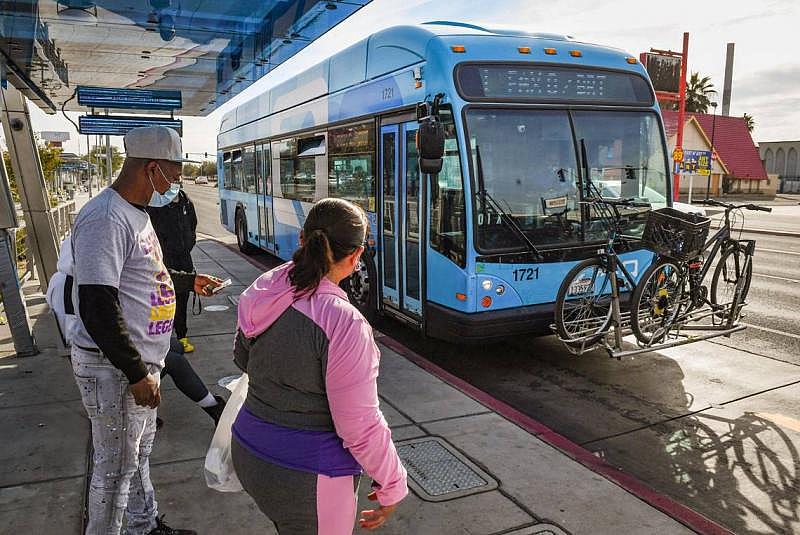 Passengers prepare to board a FAX bus at a stop near Manchester Center in Fresno on Wednesday, Oct. 20, 2021. CRAIG KOHLRUSS CKOHLRUSS@FRESNOBEE.COM 