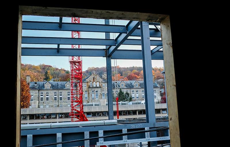 The new College of Business building rises across the street from a Fifth Street Properties student rental on Van Buren Street.  Saed Hindash | For lehighvalleylive.com