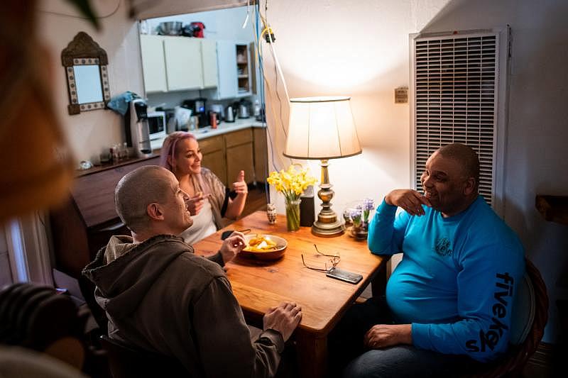 Eldridge Cruse chats with friends Bert Perla and Zarineh Agnew, in San Francisco on March 12, 2021. (Beth LaBerge/KQED)