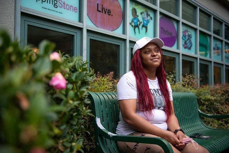 Iyana Spruell sits outside her home in San Francisco's Tenderloin neighborhood on March 14, 2022. (Beth LaBerge/KQED)