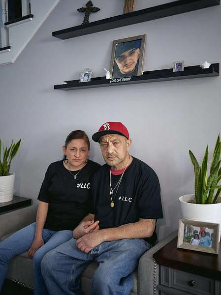 Sonia Banales and Roberto Delgado sit near a picture of their son, Daniel “Channy” Felipe Delgado, 19, who was murdered in 2020 by gun violence. Damon Casarez / The Guardian