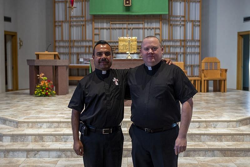 St. Marys Catholic Church has many parishioners from the immigrant community. Father Brent Lingle (right) and Deacon Hector Mora, who used to work in the Tyson turkey plant, comforted many meatpacking workers during the outbreaks. Natalie Krebs / IPR