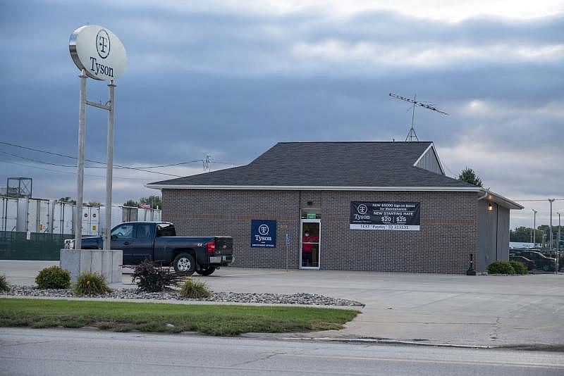 Signs posted on the Storm Lake Tyson pork plant advertise higher wages and sign on bonuses to attract workers as the meatpacking industry faces a frontline worker shortage. Natalie Krebs / IPR