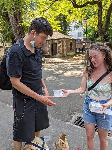 Sam Junge (left) and Hannah McDevitt are volunteers with Portland People’s Outreach Project. Here, they’re getting ready to hand out boxes of Narcan, the opioid-reversal drug, in downtown Portland. Casey Toner / BGA