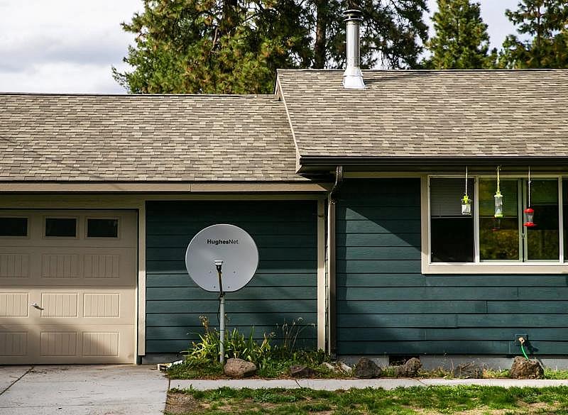 A dish for HughesNet sits unused in Faith Zacherles front yard. She switched to satellite service from Starlink, a division of Elon Musks SpaceX. (Amanda Snyder / The Seattle Times)