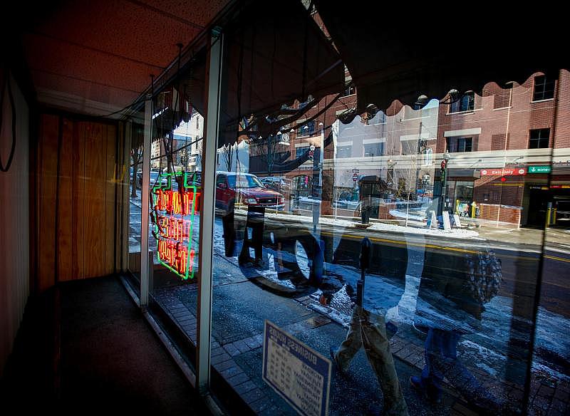 Car Village Title and Notary has been a Southside staple for almost 50 years. Its window reflects a polarizing 626-space city parking deck built to support the neighborhood's resurgence. Saed Hindash | For lehighvalleylive.com