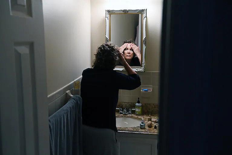 Lisa Rowe gets ready for her day, working part time as a school psychologist. (Matt McClain/The Washington Post)