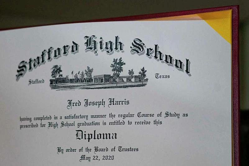 Fred's high school diploma displayed on a shelf in his mother's Stafford home. (Mark Mulligan/Houston Chronicle)