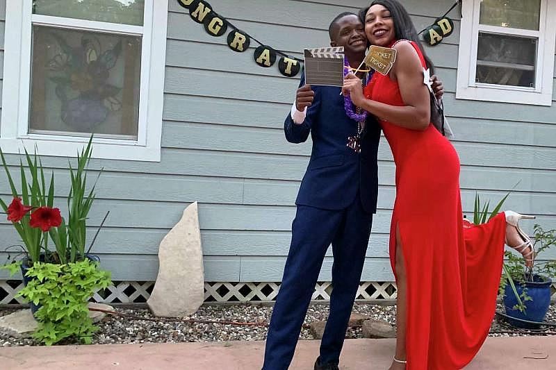 Fred Harris celebrates his high school graduation with his sister, Asa Garcia, in May 2020. Fred, who had special needs, was so disappointed that COVID led his high school to cancel prom, his family held a dance in their backyard. (Mark Mulligan/Houston Chronicle)