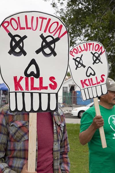 Locals protest in front of the Tesoro Oil refinery headquarters in Wilmington, California. Citizens of the Planet / Education Images / Universal Images Group via Getty Image