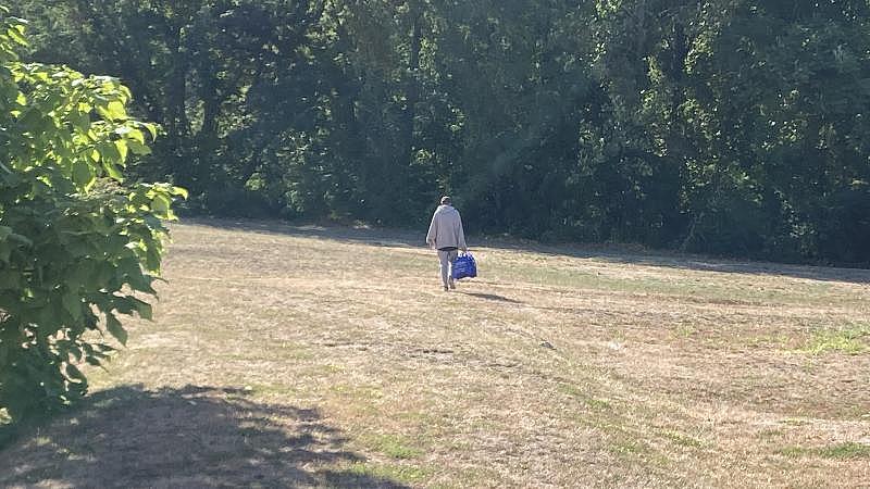 Cory heads back to his tent encampment with a bag containing naloxone and other harm reduction supplies from CODAC's mobile clinic. LYNN ARDITI/THE PUBLIC'S RADIO