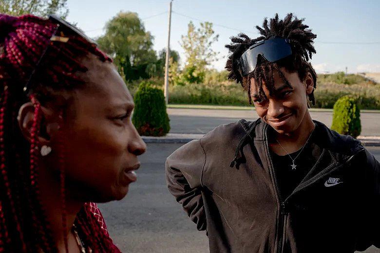 Dexter Menyfield, 15, right, talks to his mom, Tanya Austin, while waiting for an Uber outside a motel where they were staying. "He doesn't have to go through this," Austin said. "This 15-year-old, he needs his own space." YEHYUN KIM / CTMIRROR.ORG
