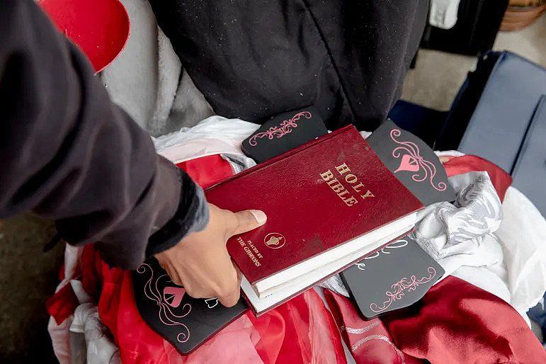 Dexter Menyfield, 15, takes the Bible out from the storage so his mom, Austin, can use it. When he and Austin were evicted and moved around between streets and hotels, he had to be absent from school for three weeks because they were not sure where they would stay for a long term. YEHYUN KIM / CTMIRROR.ORG