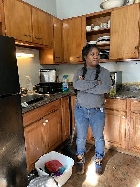 Eboni Hall stands in her apartment kitchen Thursday, Dec. 8. The Hartford apartment has a pest infestation, and earlier in the week, Hall had placed tin foil to cover a hole in the kitchen where mice were getting in. GINNY MONK / CTMIRROR.ORG