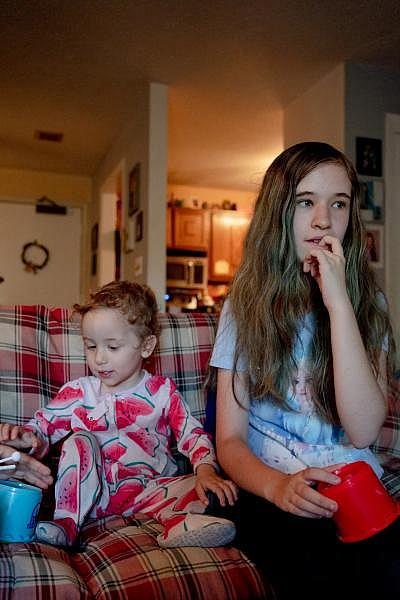 Loryann Pisani, 16, holds her sister, Bethany Cortes, 2, while adults move their belongings to move to a new place in West Hartford. “Kind of nervous,” Loryann said. “It’s new everything.” YEHYUN KIM / CTMIRROR.ORG