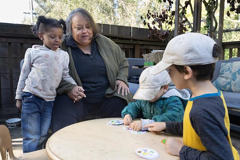 Owner Pat Sullivan (middle) supervises a card game with children at Baby Steps on Friday, Nov. 18, 2022, in San Francisco.(Paul Kuroda / For The San Diego Union-Tribune)