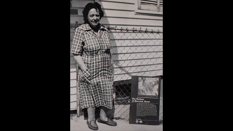 Anna Defranzo, who Fran Riley credits as the lead organizer of the Maverick Mothers, poses in front of a plaque made in her honor.