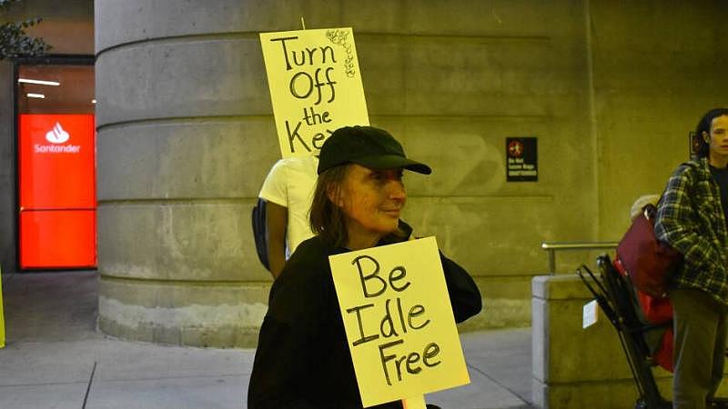 A demonstrator with Mothers Out Front stands outside of Terminal B during the evening rush. A demonstrator with Mothers Out Front stands outside of Terminal B during the evening rush.