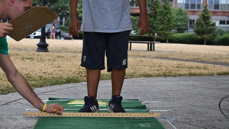 Let's Go Movin' coordinators test the physical fitness of program participants at East Boston's Memorial Park. Let's Go Movin' coordinators test the physical fitness of program participants at East Boston's Memorial Park.