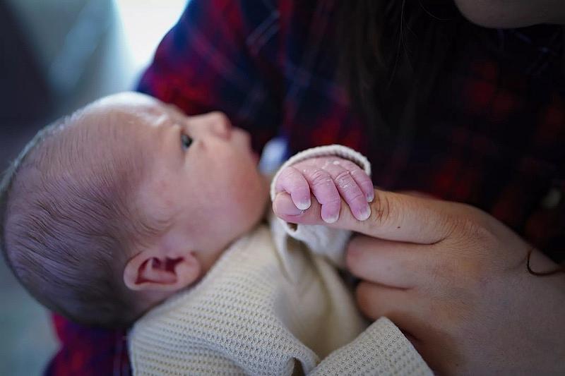 Because Zaira and Erik Reynoso cannot afford day care, she is caring for their newborn son Ander while working from home.(Nelvin C. Cepeda / The San Diego Union-Tribune)