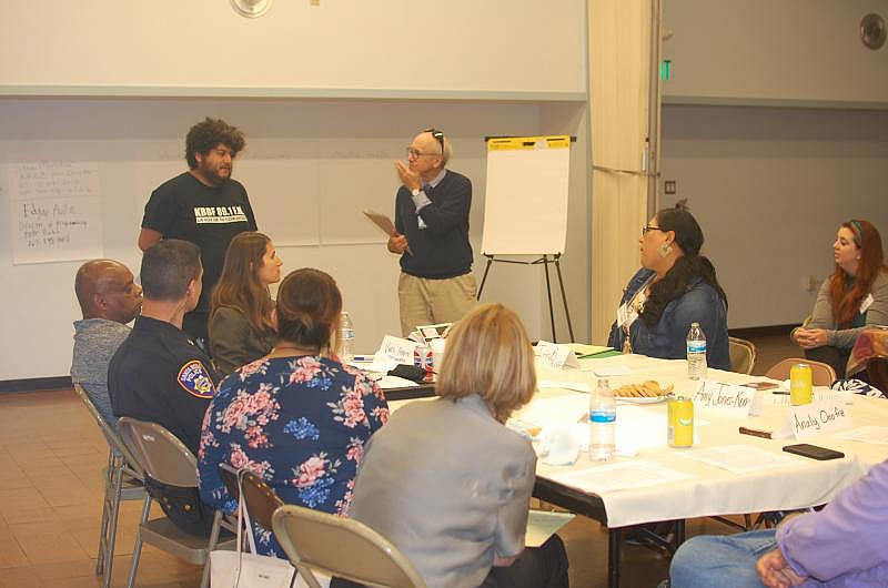 Steve Mencher and Edgar Avila lead a discussion at a community meeting to identify reporting topics.